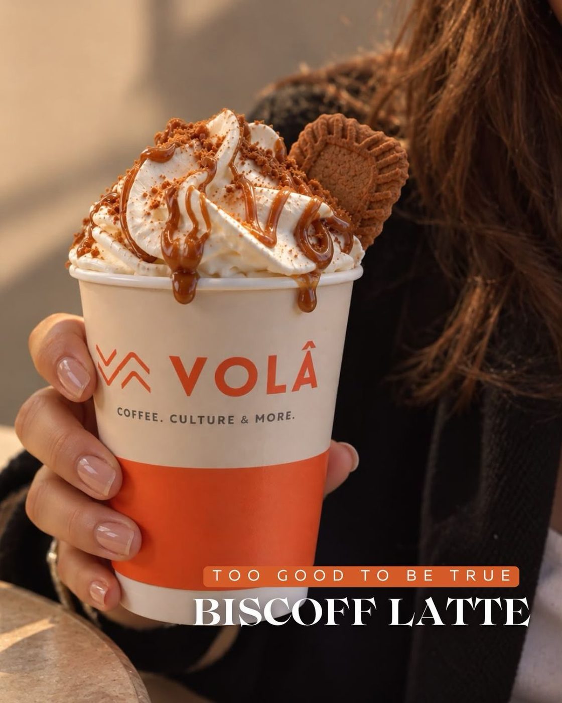 Biscoff Latte in a Volâ cup, topped with cream, caramel and a biscuit